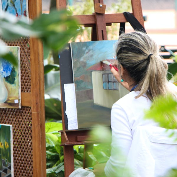 Woman Painting Outside Garden